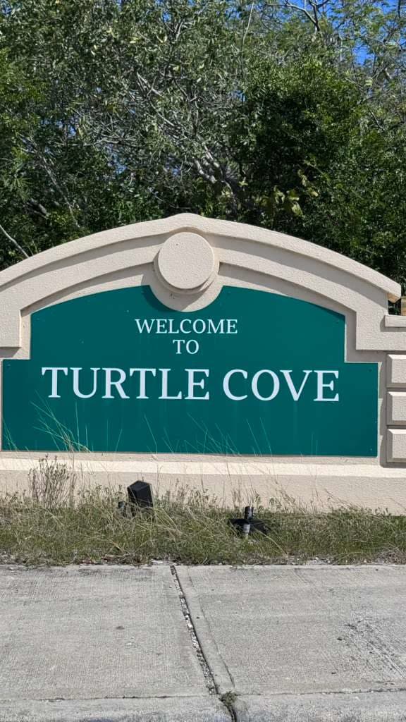 Welcome to Turtle Cove sign Providenciales Turks and Caicos Muretti